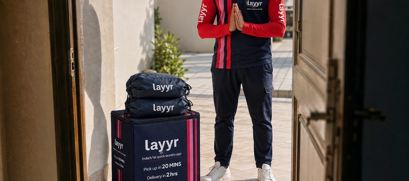 Layyr partner with striped laundry bags at a doorstep